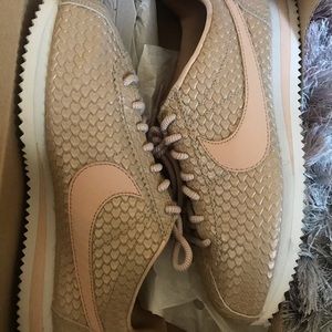 Beige and pink nike Cortez.